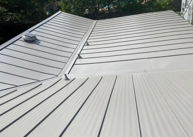 Solar attic fan installed on a metal roof for Roof Ventilation in Wauconda